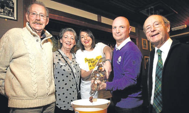 The gallon whisky bottle being emptied at the Royal Arch in Broughty Ferry. A cystic fibrosis charity was chosen because a regular at the pub, Forbes White, lost his daughter Joy to the genetic disorder. From left: Forbes, Irene and Julia White with Stephen Thompson and Jonathan Stewart.