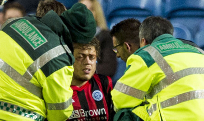 Murray Davidson gets treatment for his head knock at Ibrox.