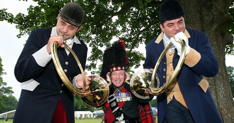 Steve MacDougall, Courier, Scone Palace Grounds, Isla Road, Perth. Scottish Game Fair photocall featuring French Hunting Group and Black Watch piper. Pictured, left to right is Loic Desre, Pipe Major Alastair Duthie (Pipe Major of 1st Battalion, The Black Watch - retired) and Sylvain Roussiere.