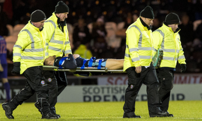 Dundee's Iain Davidson is stretchered off injured against St Mirren.