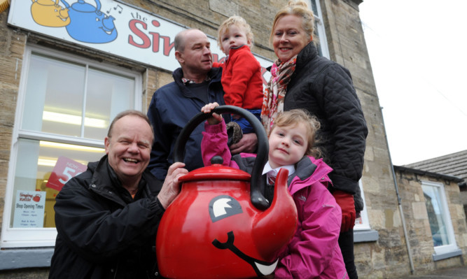 Artie Trezise, left, Pete and Douglas Small and Cilla Fisher with Eleanor Small outside the Singing Kettle shop.