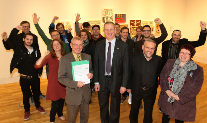 Celebrating Dundees award from Unesco are, front from left, council leader Ken Guild, Abertay University principal and vice-chancellor Nigel Seaton and director of leisure and communities Stewart Murdoch with members of the cultural team.