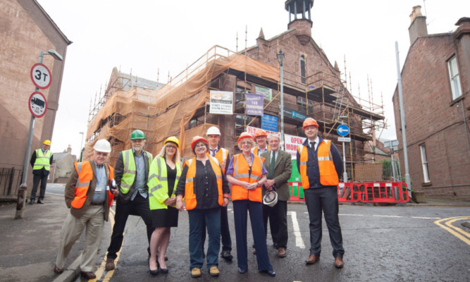 Housing Minister Margaret Burgess, fourth from right, at a visit to the restoration of the Glengate flats in Kirriemuir in July last year.