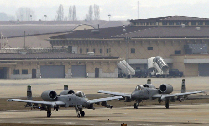 U.S. Air Force A-10 attack aircrafts wait to take off on the runway during their military exercise at the Osan U.S. Air Base in South Korea.