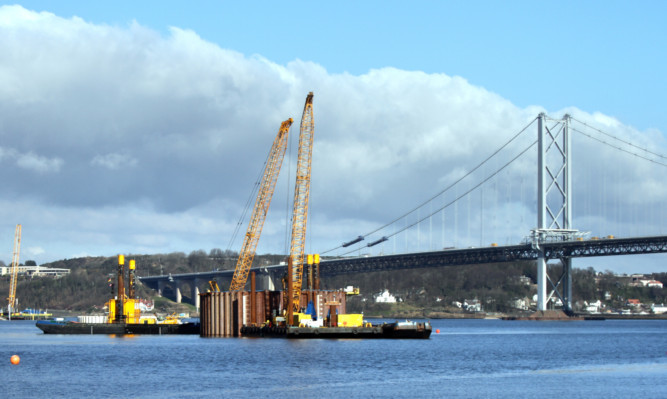 Kris Miller, Courier, 25/02/13. Picture today at River Forth crossings shows work continuing on the new Forth crossing with the old Forth Road Bridge in background.