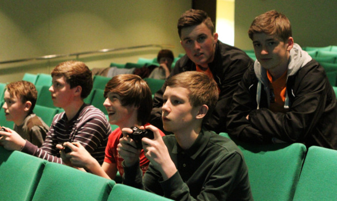 John Soutar, left, and Ryan Gauld of Dundee United watch on as the players battle it out.