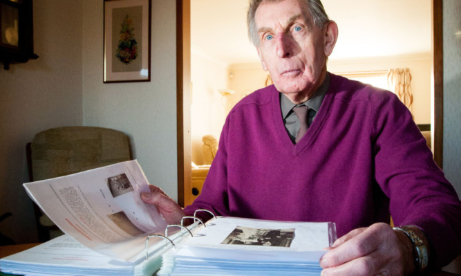 David Chalmers looking through his archives relating to his fathers contribution to Kinross County Buildings.