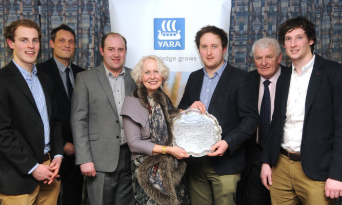 Skip Allan Marshall receives the silver salver from Yaras marketing manager Rosie Carne, watched by team members, at front, Kyle Smith, Colin Reid and Colin Howden; and, at back, Yaras managing director Benoit Lamaison and area manager Alan Wood.