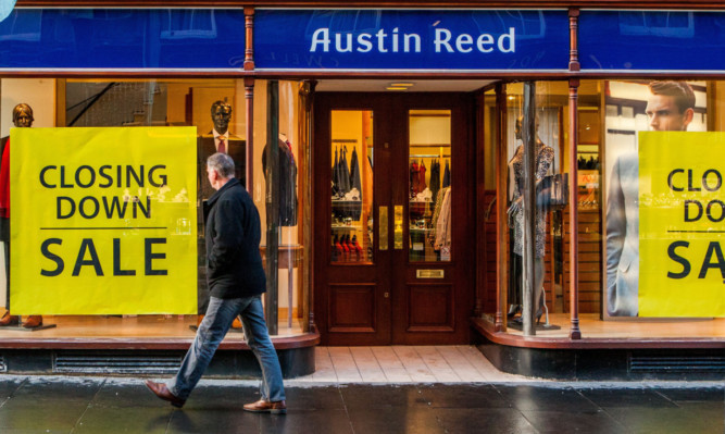 A man walks past the citys Austin Reed store. The company said it will explore redeployment opportunities with affected members of staff.
