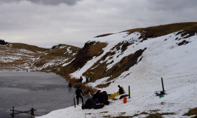 Divers search Loch Dow for the body of Mr McKenzie.