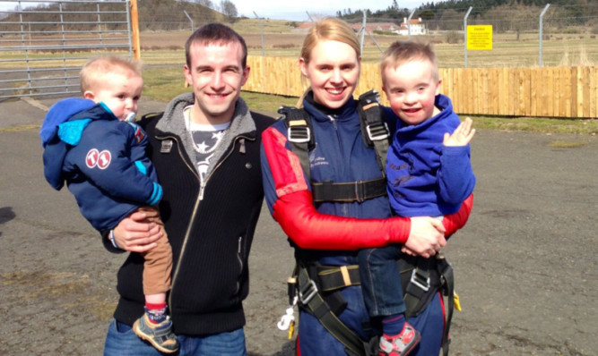 Jacqueline Watson with husband Scott and sons Kai and Logan.