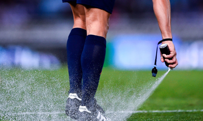 SAN SEBASTIAN, SPAIN - NOVEMBER 28:  Referee Velasco Carballo uses vanishing spray during the La Liga match between Real Socided and Elche FC at Estadio Anoeta on November 28, 2014 in San Sebastian, Spain.  (Photo by David Ramos/Getty Images)