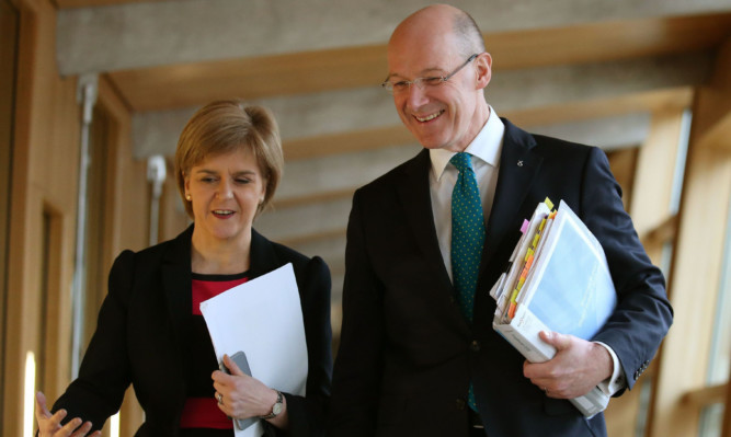 First Minister Nicola Sturgeon and deputy John Swinney head to the chamber to present the budget.