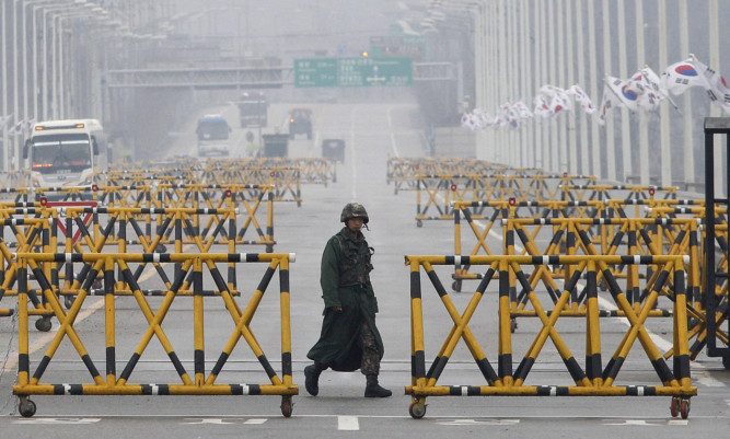 A South Korean Army soldier walks on Unification Bridge in Paju, South Korea.