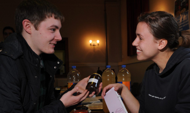 Ronan Kearney barters with Maria Cooper for some of her jams and chutneys.