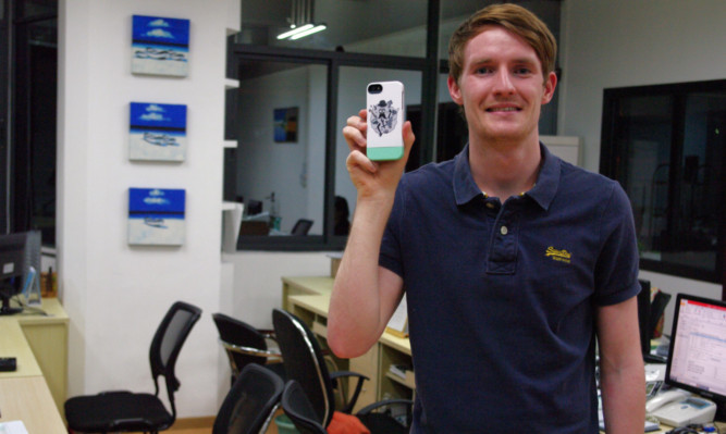 Steve Murray with one of the charity phone cases he has helped to develop.