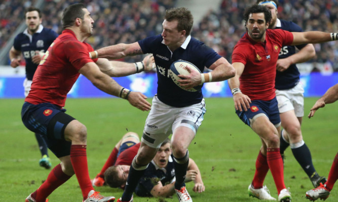 Stuart Hogg goes through more French defenders in Paris.