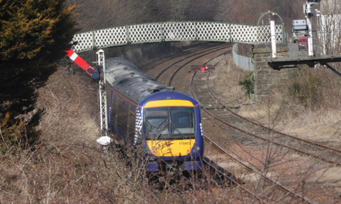 A train passes under the footbridge at Dens Road where the vacuum cleaner incident took place.