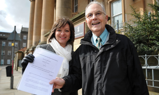 Jenny Marra and George Stewart outside Dundee Sheriff Court with the petition on the proposed closure of the Kemback Street Centre.