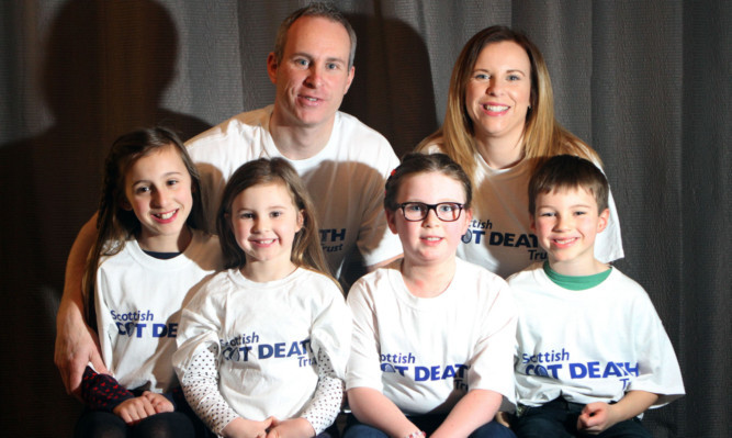 The family who will take part in a charity swim to raise funds and awareness for the Scottish Cot Death Trust on February 22. Front, from left: Ellie Murray, Ruby Brown, Lola Murray and Nairn Brown. Back: Simon Murray and Lois Brown.