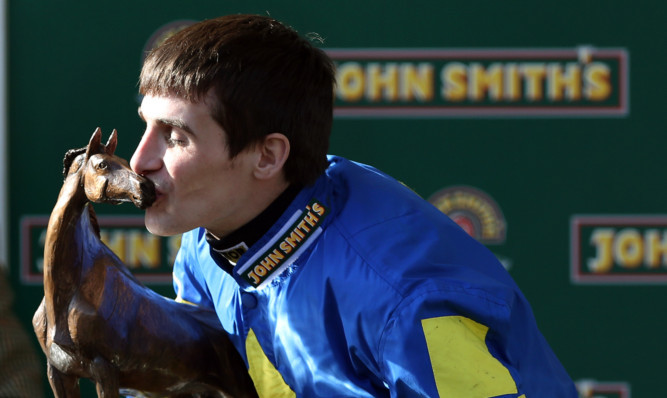 Ryan Mania kisses the Grand National Trophy.