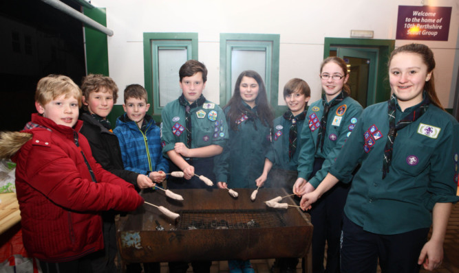 Scouts enjoy a barbecue.