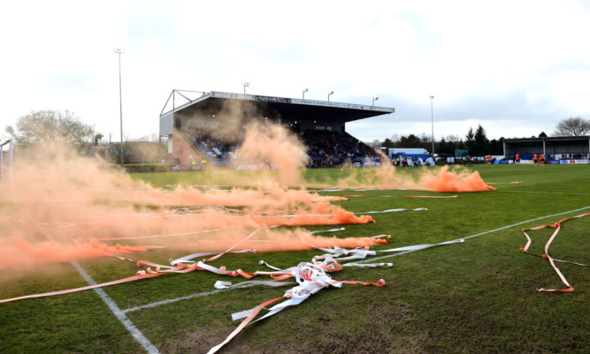 Flares on the pitch at Stair Park.