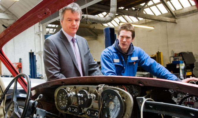 Steve MacDougall, Courier, Classic Restorations, Pitnacree Street, Alyth. Secretary of State Michael Moore visiting classic car business. Pictured, Michale Moore (left) chats with mechanic Neil Tuer beside one of the classic cars.