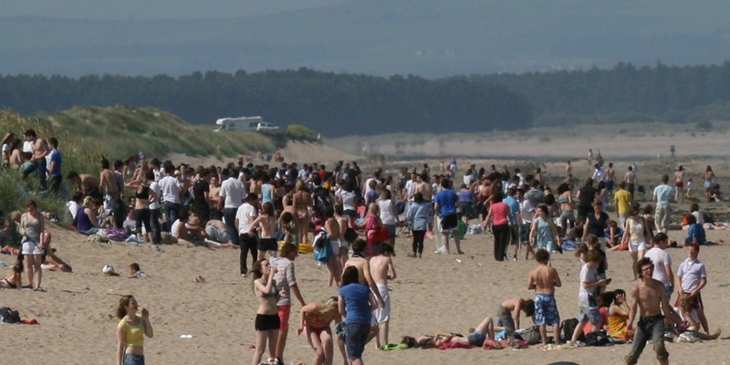 Heatwave - Busy scene at St Andrews West Sands.  Crowds enjoy the soaring temps today.