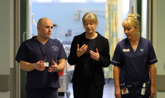 Health Secretary Shona Robison (centre) has been urged to order an inquiry into the cancellation of operations in NHS Fife.