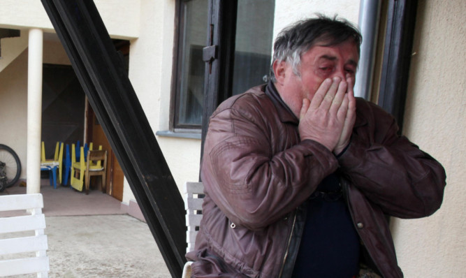 Radmilo Bogdanovic, brother of Ljubisa Bogdanovic cries in the village of Velika Ivanca, Serbia, after his brother went on a gun rampage, killing 13 people.