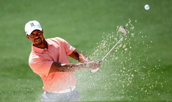 Tiger Woods hits out of the bunker during a practice round.