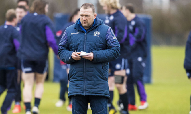Scotland forwards coach Johnathan Humphreys checks his notes during training yesterday.