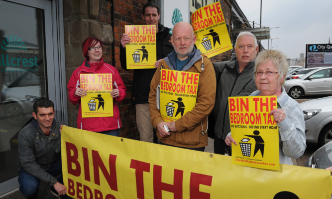 (From left) Protesters Sean Robertson, Elizabeth Reddy, Michael Tunstall, Philip Stott, Iain Brown and June Paterson outside the Hillcrest Housing offices.