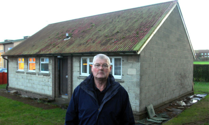 Janitor Jim Hayter outside his tied house at Sidlaw View Primary School.