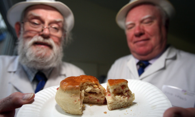John Young and David Briggs check out the competition at the Scottish Baker of the Year 2013 competition .
