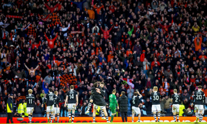 United fans and players celebrate at Hampden after beating Aberdeen to reach the final.