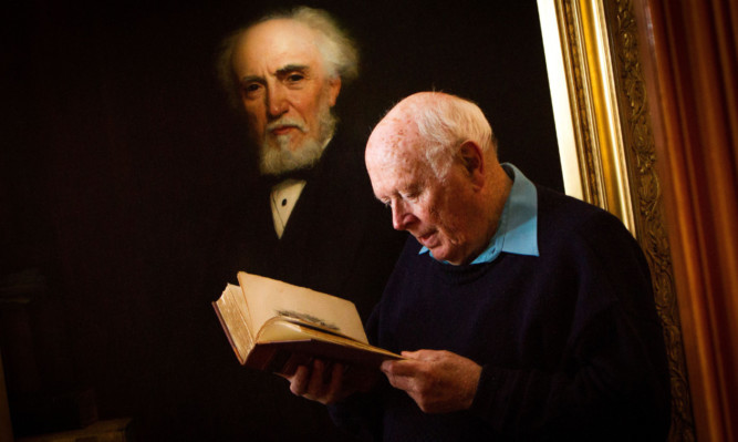 David Verden-Anderson in front of the painting of his ancestor Alexander Laing.