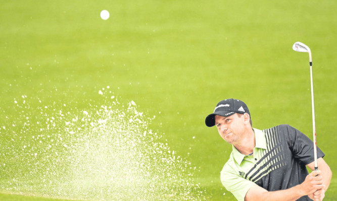 Sergio Garcia blasts out of a bunker on the second hole.