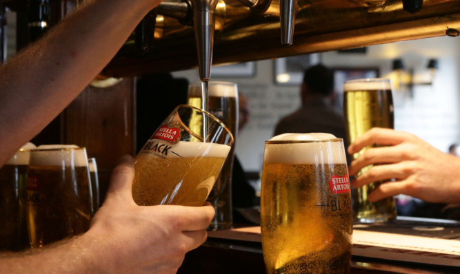 Drinks being poured at the bar of Irish pub O'Neill's in Carnaby Street, central London. PRESS ASSOCIATION Photo. Picture date: Friday April 18, 2014. Photo credit should read: Yui Mok/PA Wire