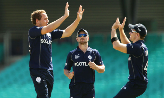 Josh Davey of Scotland celebrates with team mates after taking the wicket of Marlon Samuels of West Indies during an ICC Cricket World Cup warm-up match between the West Indies and Scotland earlier this week.
