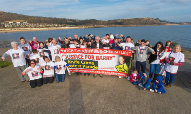 Family and friends of Barry McLean give a thumbs-down to knife crime.