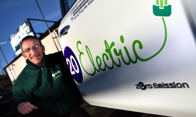 Driver Duncan Menzies with one of the 203020 electric taxis.