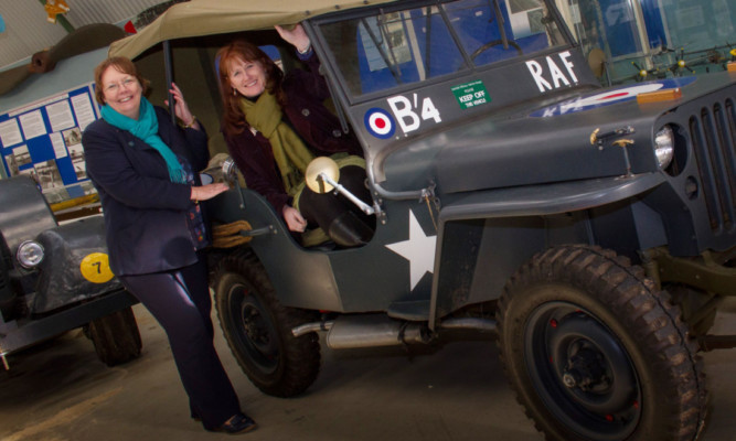 Alison McInnes, left, MSP for North East Scotland with Joanne Orr, CEO of Museum Galleries Scotland, trying out one of the vehicles on display at Montrose Air Station Heritage Centre.