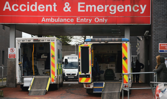 GLASGOW, SCOTLAND - FEBRUARY 03:  Ambulances are parked at the entrance to Glasgow Royal Infirmary accident and emergency on February 3, 2015 in Glasgow, Scotland. Figures released today show that Accident and Emergency departments treated ninety one percent of patients within four hours between October and December, worse than England's performance for the same quarter.  (Photo by Jeff J Mitchell/Getty Images)