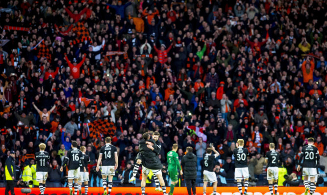 Dundee Utd fans roar with pride as their team celebrate in front of them