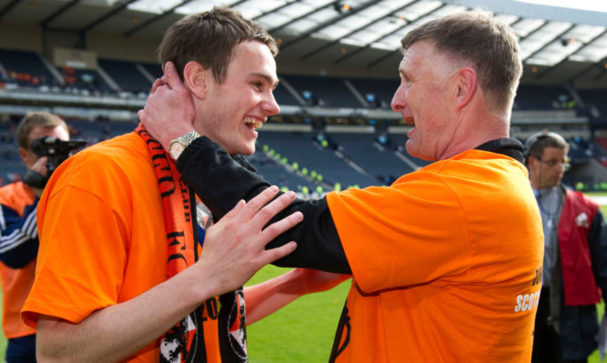 Keith Watson celebrates United's 2010 cup win with coach Paul Hegarty.