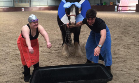 Rider and volunteer Molly Urquhart and Brae physiotherapist Duncan Sangster try to encourage Romany to make a splash for the charity.