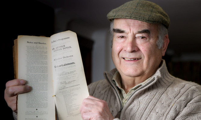 Walter Elliot with his book containing a short Sherlock Holmes story by Sir Arthur Conan Doyle.