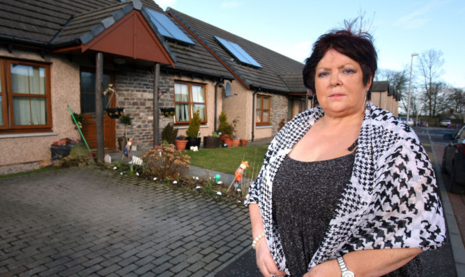 Joan Boyle says she is terrified to leave her house after neighbour Ian Spence was fined for attacking her.
